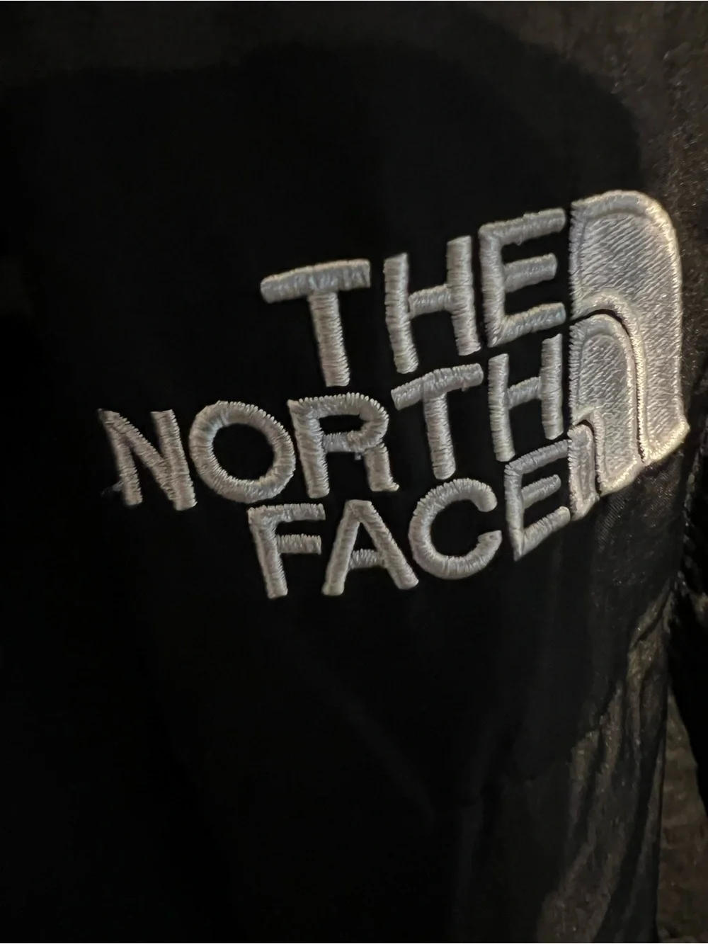 The North Face Black Jacket with white embroidered Tag Detail